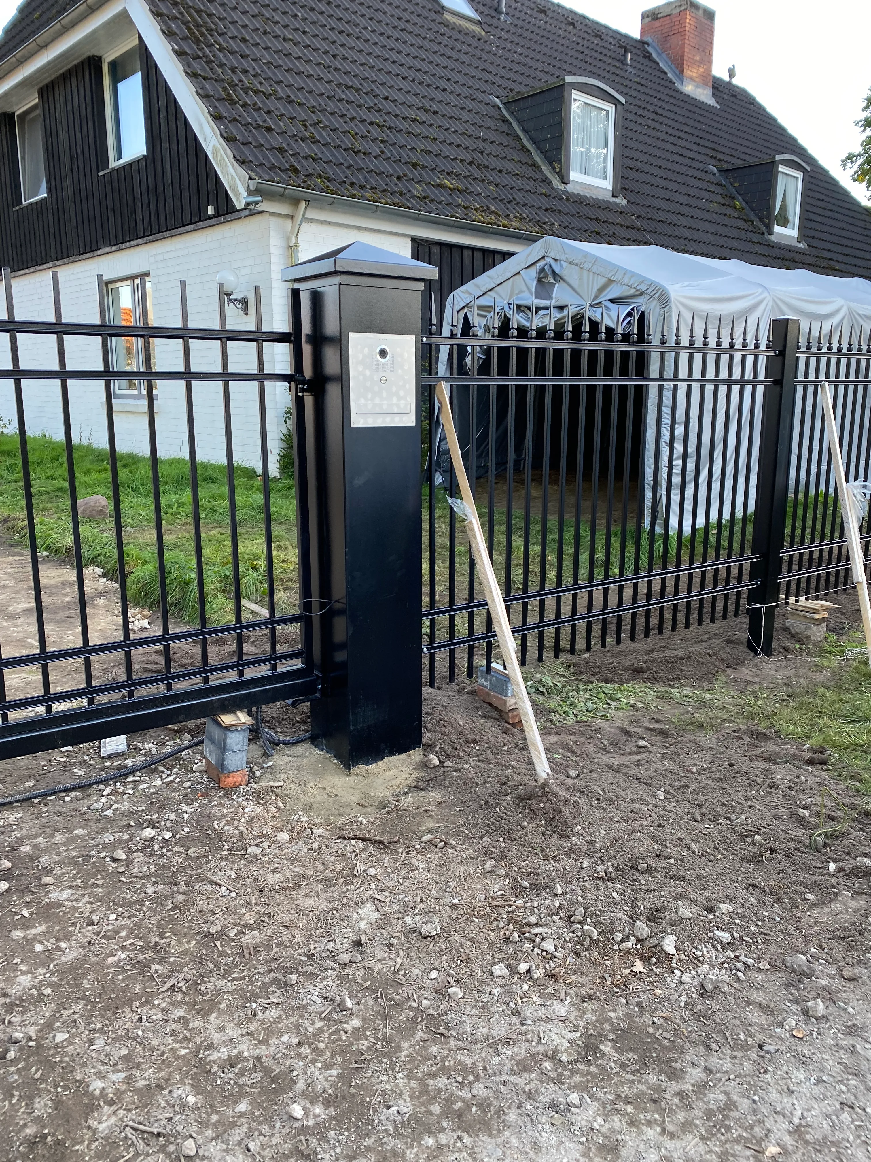 Sichtschutzzaun mit modernem Design und Zutrittskontrolle an einem Wohnhaus